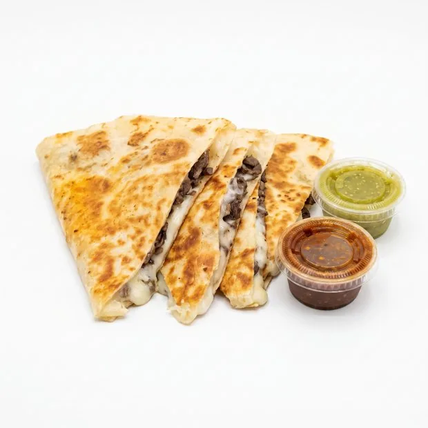 Steak quesadilla cut in wedges with green and red salsa cups