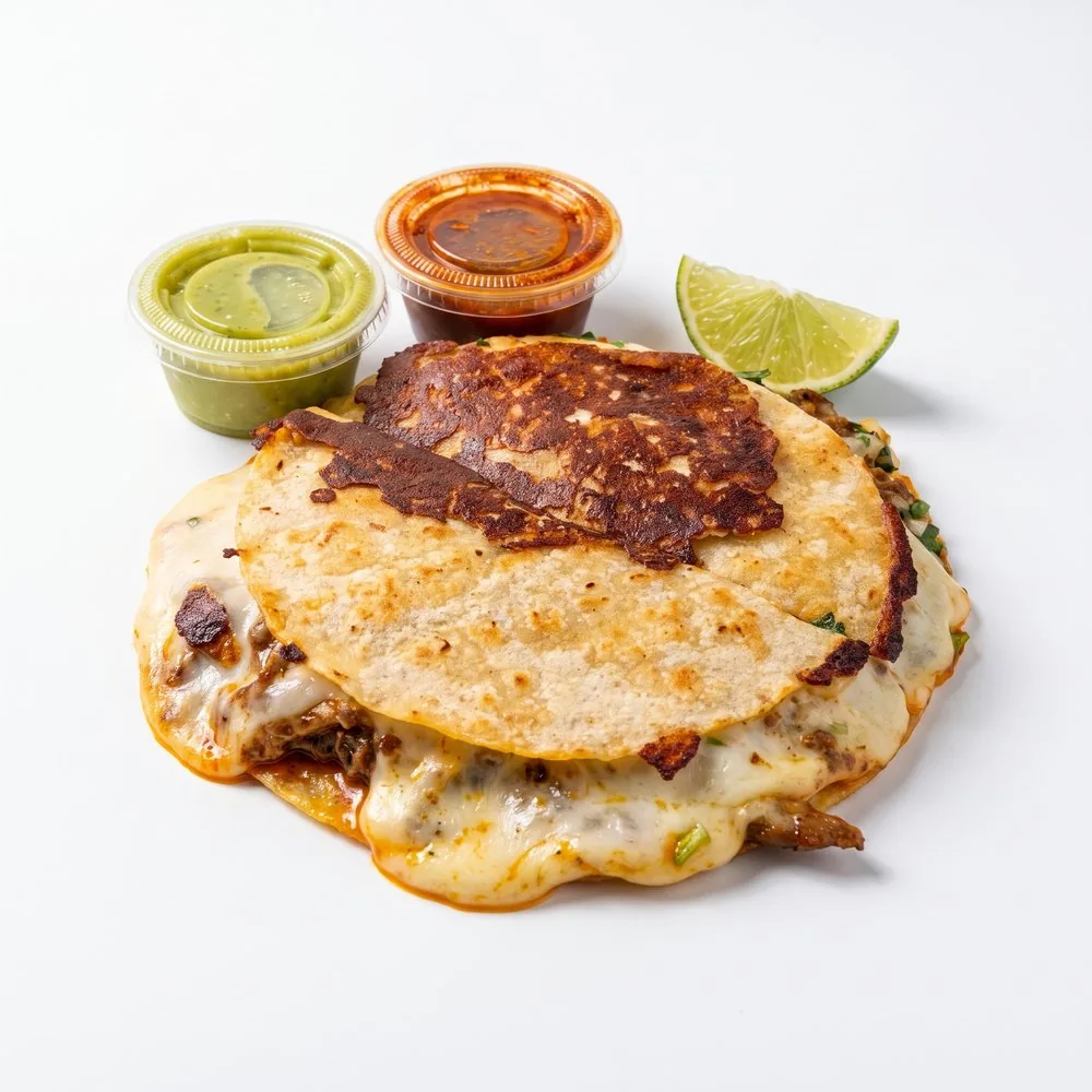 Mulita, griddled crisp with the cheese running out, salsa cups and lime