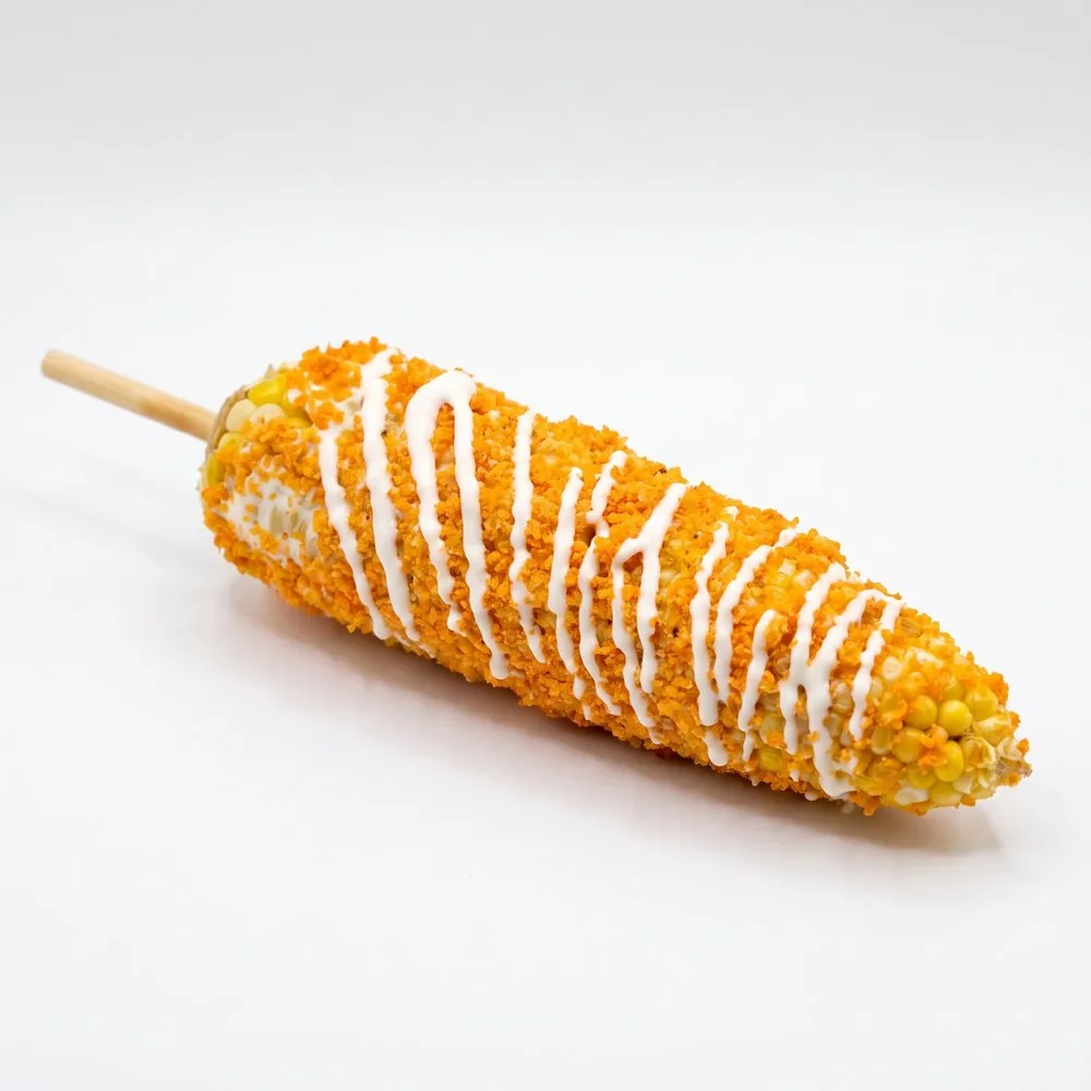 Elote on a stick with crema, cheese and chili
