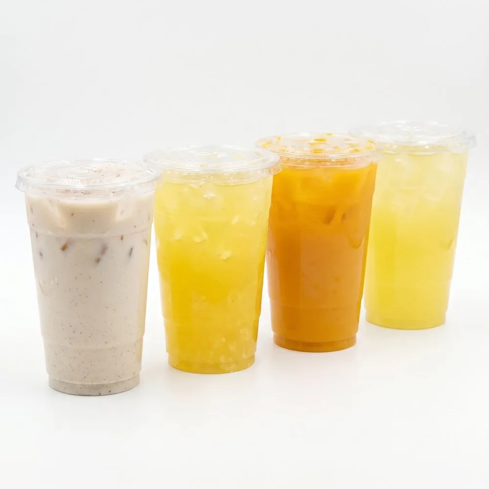 Four aguas frescas in cups: horchata, piña, mango and melón