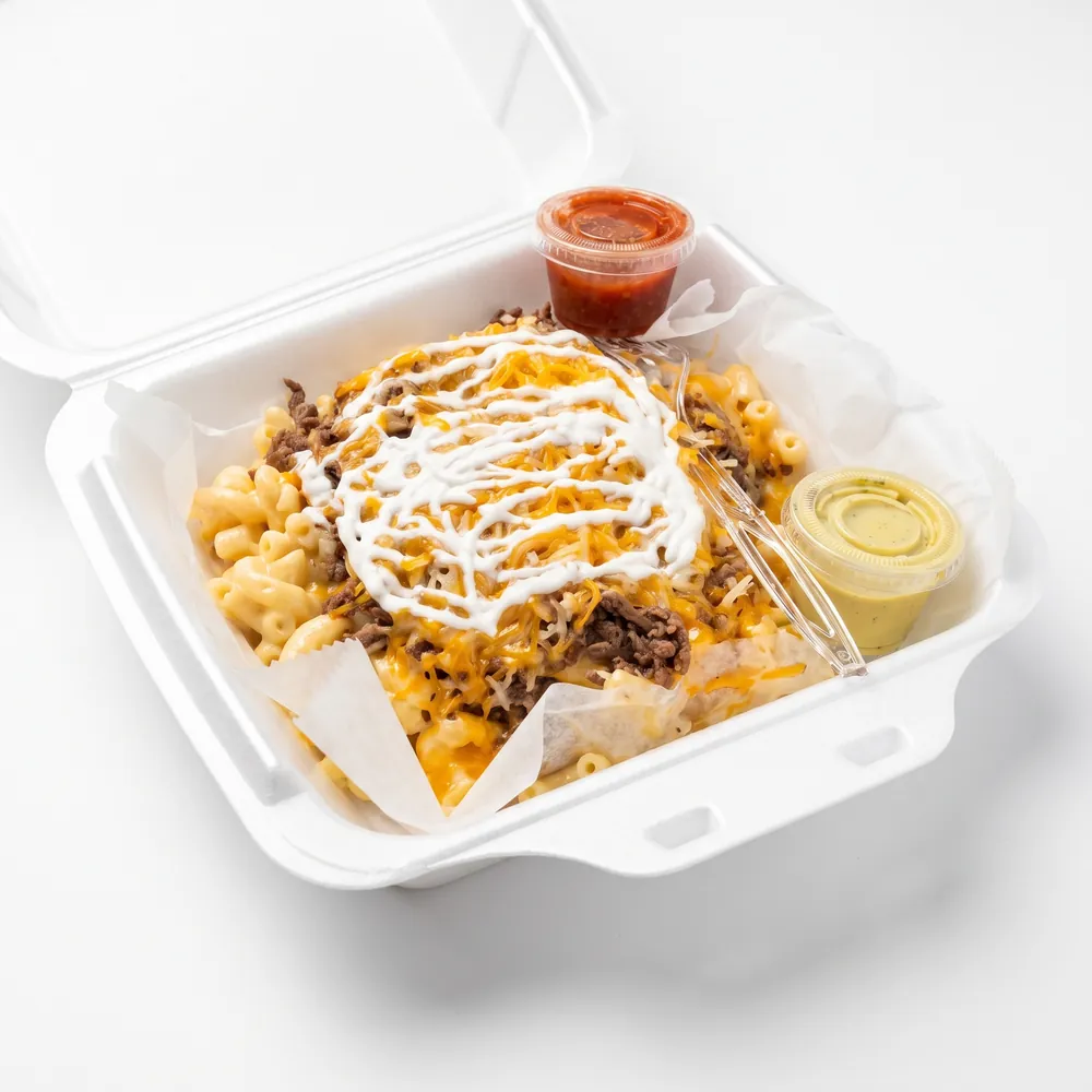 Perry Plate in a to-go box: macaroni and cheese topped with steak, shredded cheese and sour cream